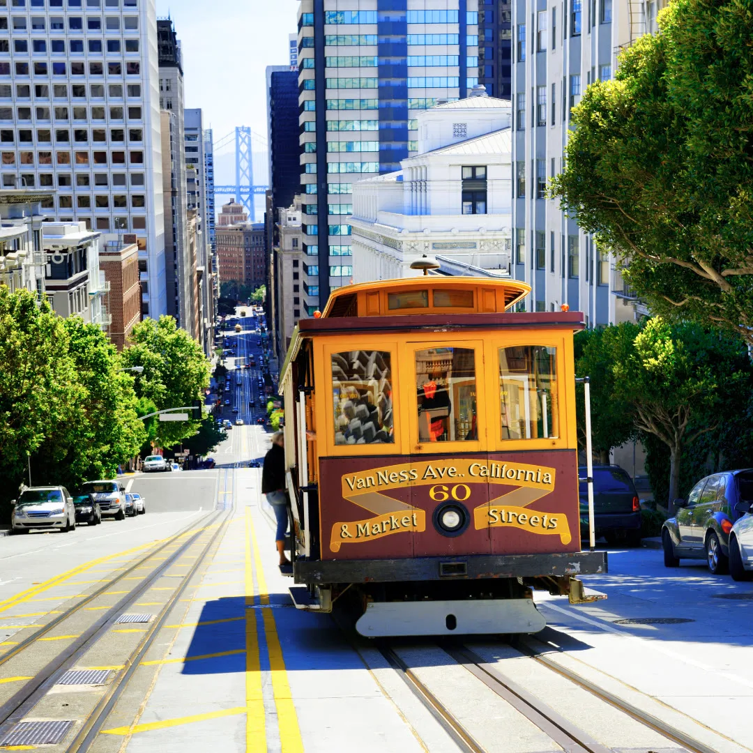 A San Francisco cable car climbing a sunny street