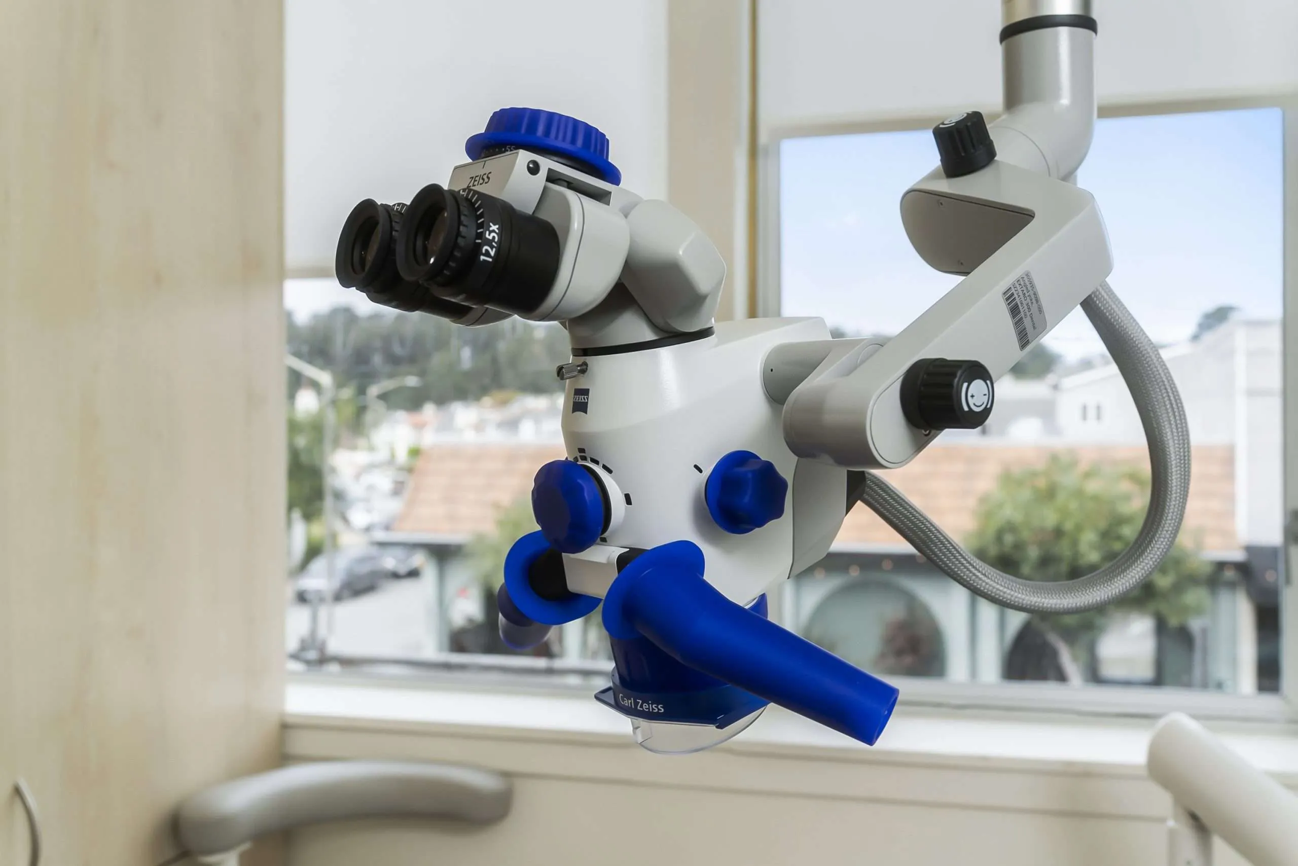 The operating microscope beside an orchid in the window light