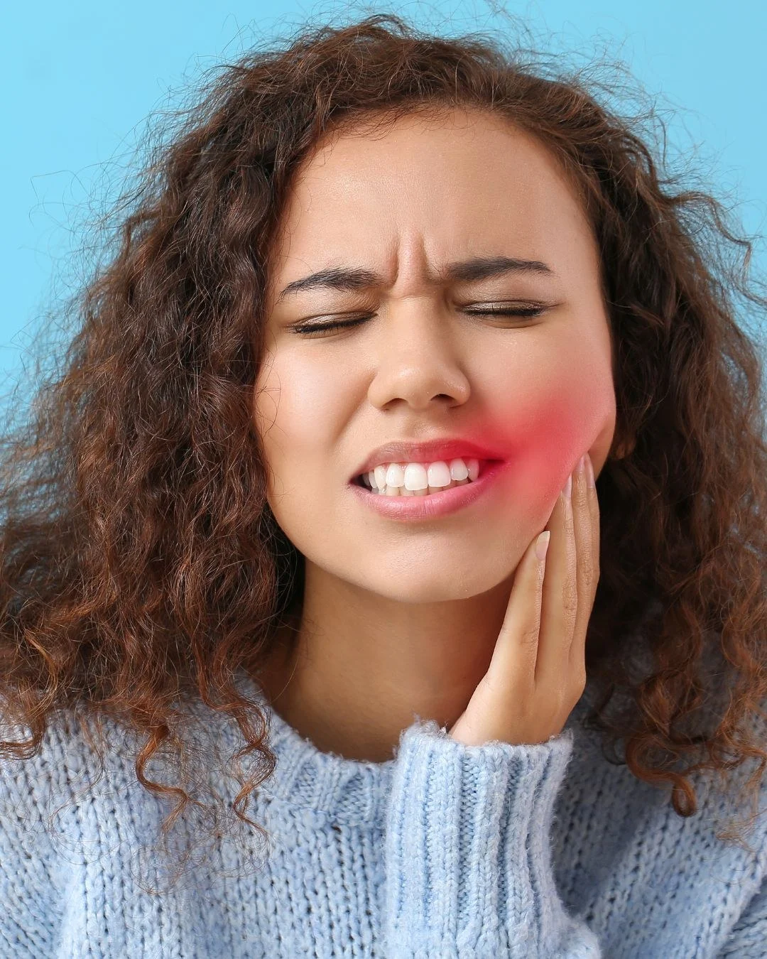 A person holding their jaw, with the area of tooth pain highlighted